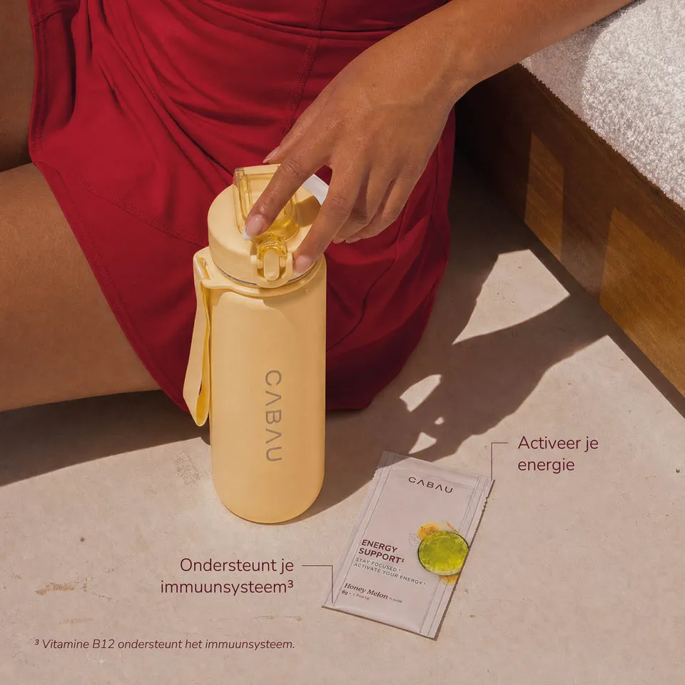 A hand pouring a Cabau sachet into a bottle