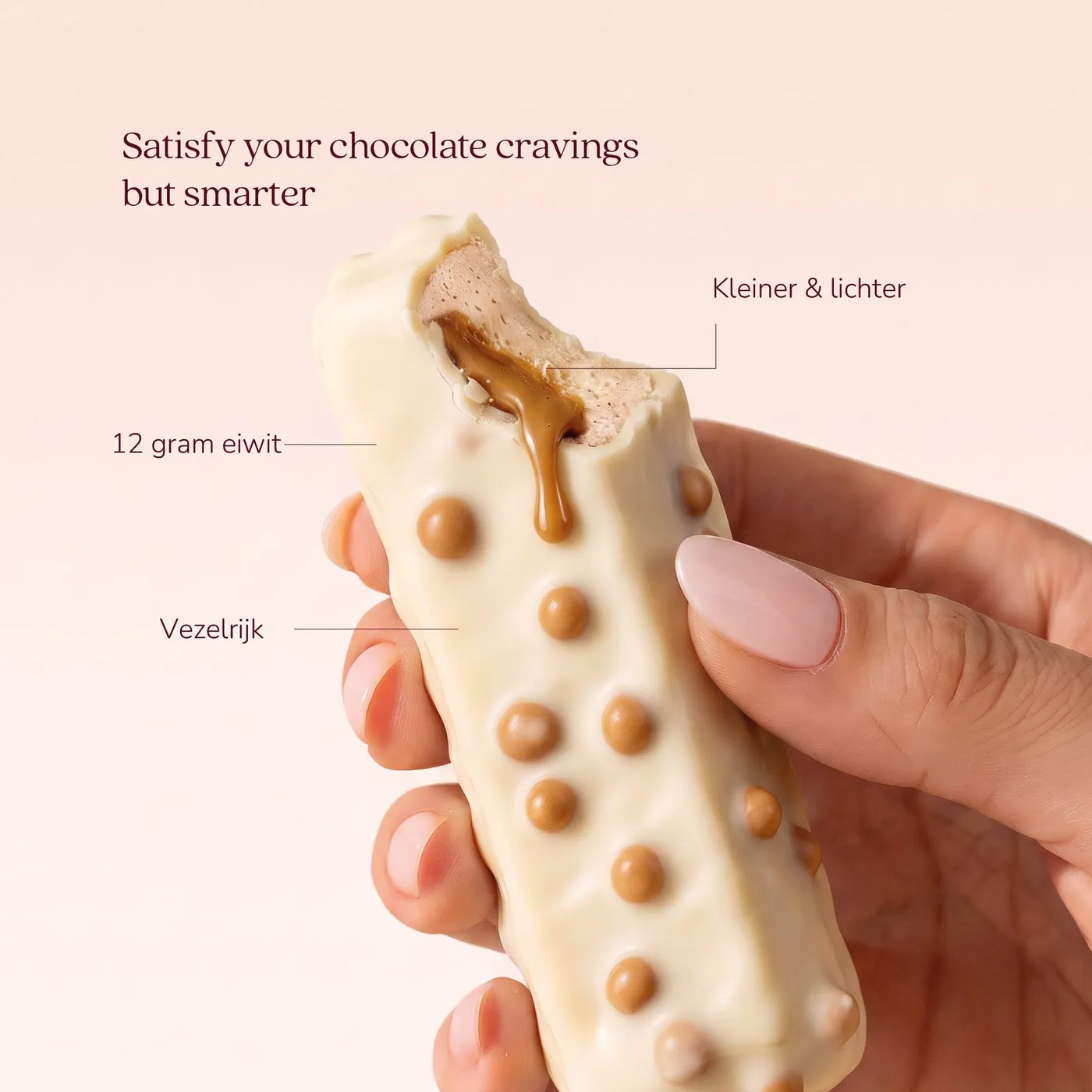 A hand holding a Smart Protein Bar with a bite taken out