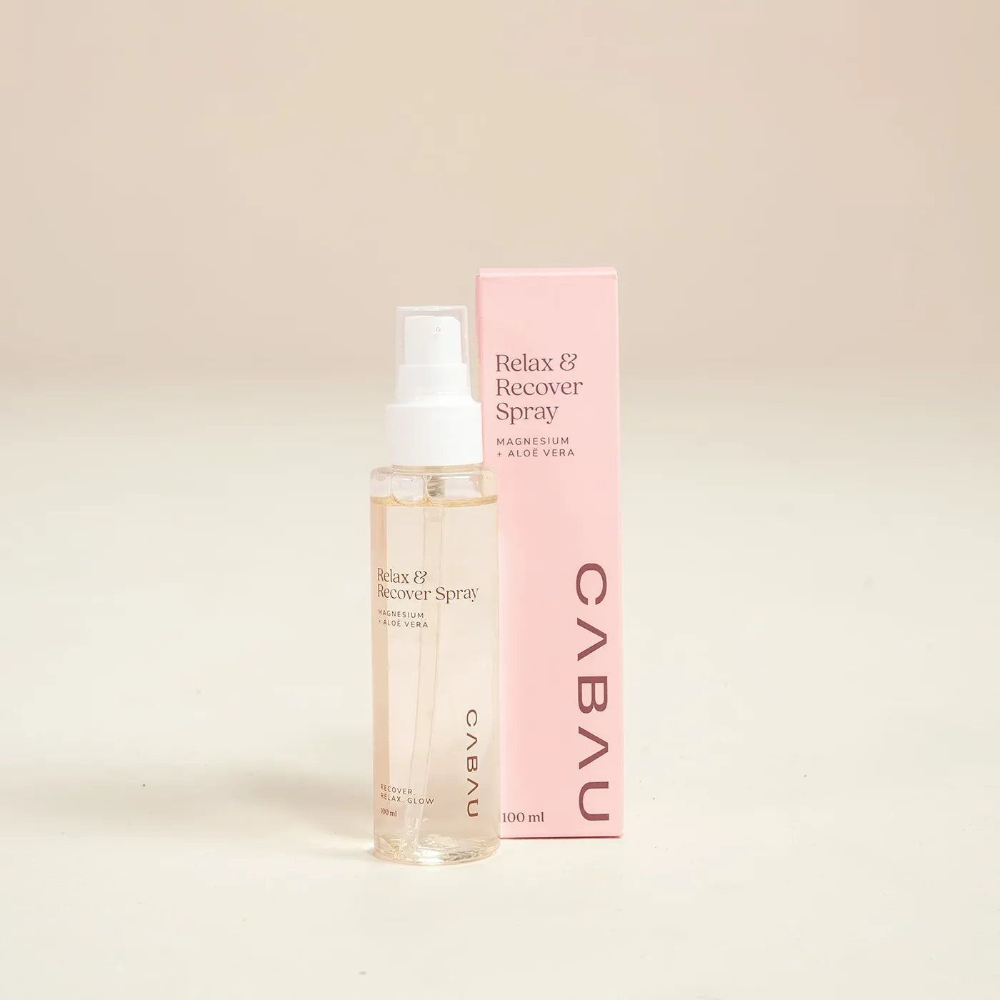 A clear Cabau room spray bottle with a pink cap