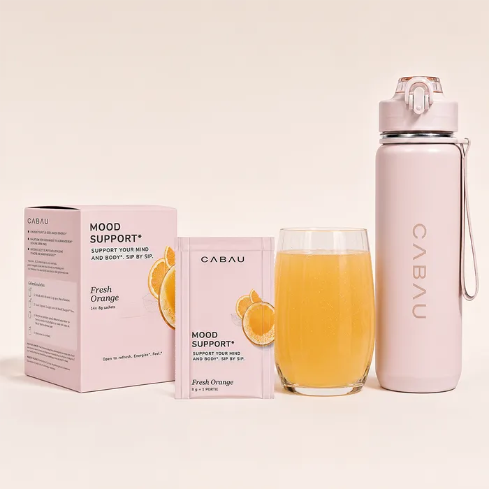 Mood Support box beside a pink bottle and a glass of orange drink